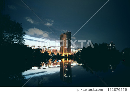 A city building built on the shore of a reservoir at night A city building built on the shore of a reservoir at night 131876256