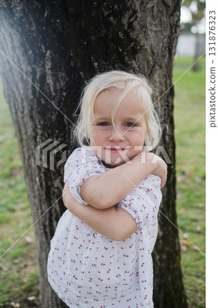 Little 4-year-old girl hugging herself Little 4-year-old girl hugging herself 131876323