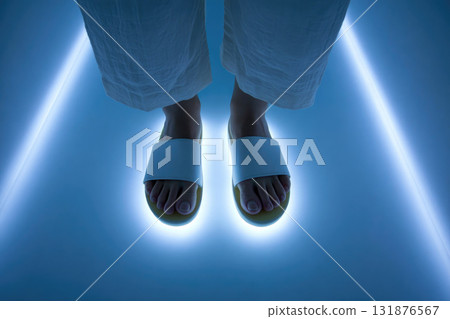 White sandal foot blue light modern minimal fashion woman standing glowing futuristic. White sandal foot standing glowing blue light floor modern minimal fashion style woman relaxed pose White sandal foot blue light modern minimal fashion woman standing glowing futuristic. White sandal foot standing glowing blue light floor modern minimal fashion style woman relaxed pose 131876567