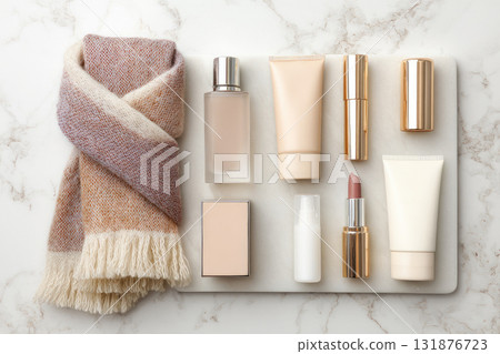 Flat lay of luxury skincare products, lipstick, and wool scarf on marble background, featuring elegant gold packaging, soft textures, and cozy, sophisticated atmosphere Flat lay of luxury skincare products, lipstick, and wool scarf on marble background, featuring elegant gold packaging, soft textures, and cozy, sophisticated atmosphere 131876723