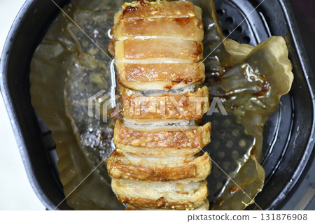 Roast pork loin with crispy golden skin sliced on parchment, savory glaze and steaming juices evoking comfort and appetite Roast pork loin with crispy golden skin sliced on parchment, savory glaze and steaming juices evoking comfort and appetite 131876908