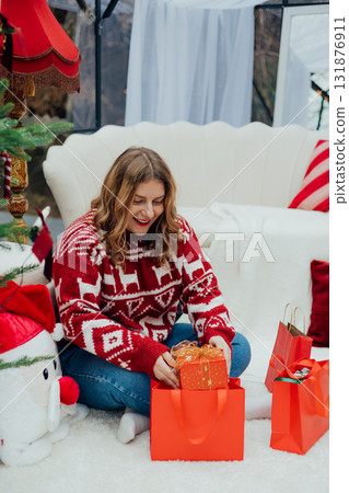 Middle age Caucasian woman smiling confident holding Christmas gift bag at home. Winter time and holidays. Celebration banner, big sale concept Middle age Caucasian woman smiling confident holding Christmas gift bag at home. Winter time and holidays. Celebration banner, big sale concept 131876911