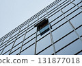 Glass facade of modern building with open window 131877018