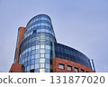 Modern glass office building against blue sky 131877020