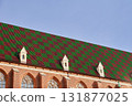 Gothic building roof with colorful patterned tiles 131877025