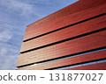 Red modern building facade with narrow windows 131877027