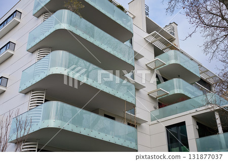 Modern apartment building with glass balconies in city 131877037