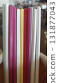 Colorful plastic drinking straw bundle standing upright with soft cafe background and warm mood 131877043