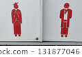 Red restroom symbol of woman and man traditional clothing, minimalist signage, cultural icon, gendered bathroom marker, bright contrast, calm mood 131877046