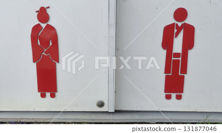 Red restroom symbol of woman and man traditional clothing, minimalist signage, cultural icon, gendered bathroom marker, bright contrast, calm mood 131877046