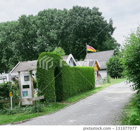 A signpost in a lush green area with directions to a beach and tourist information A signpost in a lush green area with directions to a beach and tourist information 131877077
