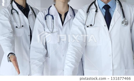 Medical team offering helping hands, extending invitation for support and showing professional care, welcoming patients to healthcare services with open palms Medical team offering helping hands, extending invitation for support and showing professional care, welcoming patients to healthcare services with open palms 131877466