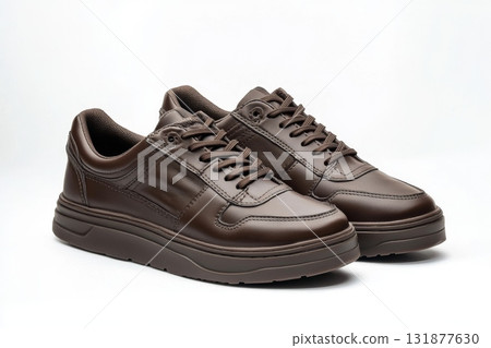 Dark brown leather lace-up running shoes with low tops, thick soles. The laces and black rubber outsole. Sporty look. Men to wear during outdoor activities, hiking. Brown shoes. Trendy Male Boots Pair 131877630