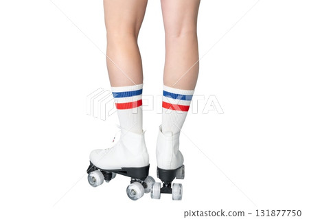 Caucasian female teen wearing roller skates and striped socks 131877750