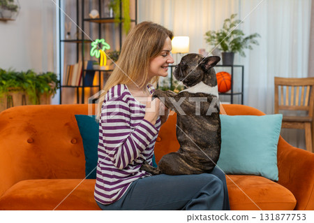 Middle-aged woman with dog close face portrait smiles nose to nose tender moment love and joy detail Middle-aged woman with dog close face portrait smiles nose to nose tender moment love and joy detail 131877753
