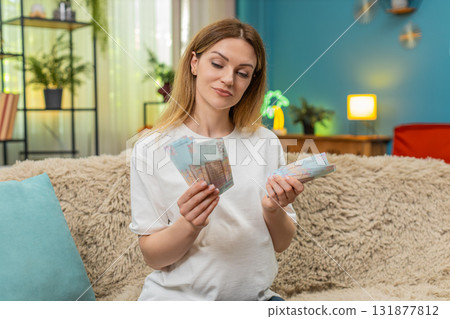 Pregnant woman counts UAH Ukrainian hryvnia cash planning baby birth budget money preparation Pregnant woman counts UAH Ukrainian hryvnia cash planning baby birth budget money preparation 131877812