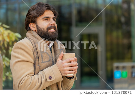 Indian young businessman tourist enjoying drinking morning warming hot takeout coffee, tea beverage 131878071