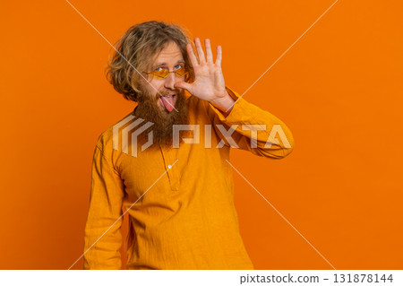 Funny comical Caucasian man making silly facial expressions grimacing fooling around showing tongue Funny comical Caucasian man making silly facial expressions grimacing fooling around showing tongue 131878144