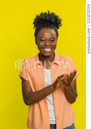 African American woman laughing joyfully, clapping hands, cheerful expression, celebrating good work 131878354