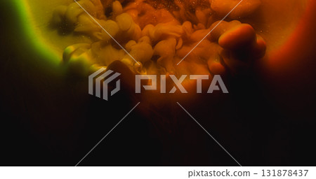 Paint blend. Color cloud texture. Defocused orange green red splash rainbow vapor glitter water spreading on abstract dark black background. 131878437