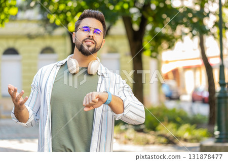 Man looking for someone waiting for meeting angry frustrated look time touching wristwatch on street Man looking for someone waiting for meeting angry frustrated look time touching wristwatch on street 131878477