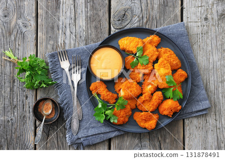 breaded chicken breast chunks with dipping sauce 131878491