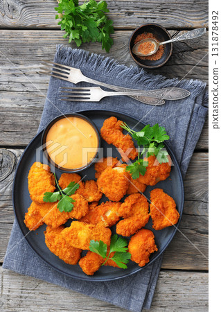 breaded chicken breast chunks with dipping sauce 131878492
