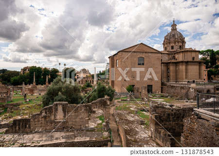 Ancient Roman ruins and historical buildings under dramatic cloudy sky in Rome Ancient Roman ruins and historical buildings under dramatic cloudy sky in Rome 131878543
