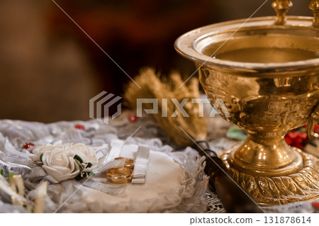 Orthodox Wedding Ceremony: Gold Chalice, Rings, Roses and Lace on Altar Table, Spiritual Tradition, Faith, Golden Tone, Religious Setting Orthodox Wedding Ceremony: Gold Chalice, Rings, Roses and Lace on Altar Table, Spiritual Tradition, Faith, Golden Tone, Religious Setting 131878614