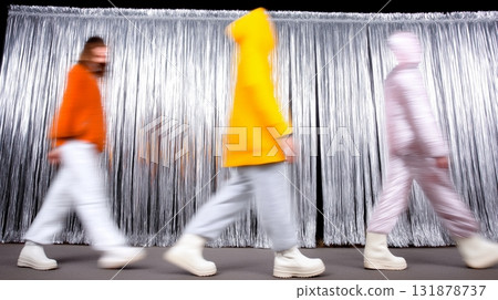 Blurry fashion show with stylish outfits and silver background Blurry fashion show with stylish outfits and silver background 131878737