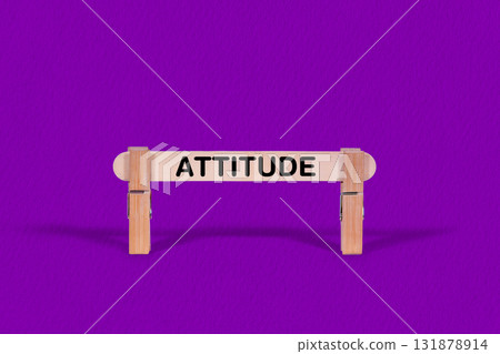 Attitude symbol. Wooden stick suspended by Clothespins, Purple hues Backdrop. Business and Attitude concept with copy space Attitude symbol. Wooden stick suspended by Clothespins, Purple hues Backdrop. Business and Attitude concept with copy space 131878914