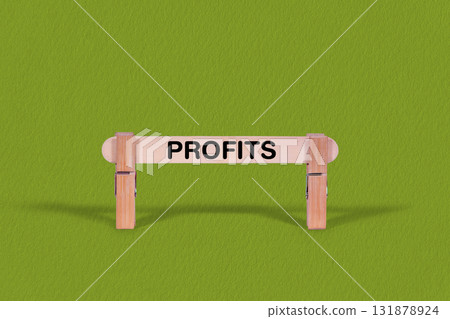 Profits symbol. Wooden stick anchored by Clothespins, Cool Green Background. Business and Profits concept with copy space 131878924