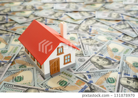 A house built on dollar bills. Housing and square footage prices. Expensive land and real estate. Concept of financial dependence in housing markets. Real estate investment, mortgage rates 131878970