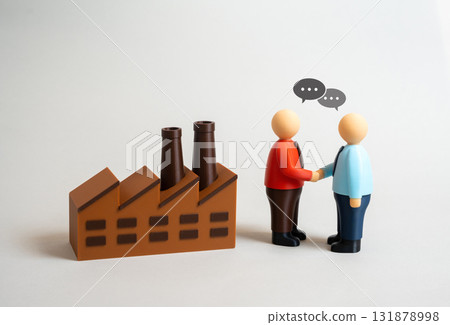 People shaking hands near a factory. Signing a contract with an industrial enterprise and a customer. Investment agreement. Hiring at the plant. Industrial partnership, economic cooperation People shaking hands near a factory. Signing a contract with an industrial enterprise and a customer. Investment agreement. Hiring at the plant. Industrial partnership, economic cooperation 131878998