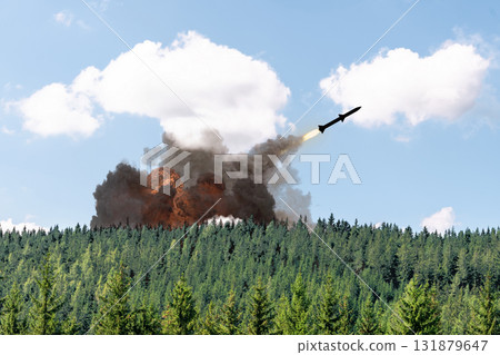Launch of a missile from an anti-missile installation in a green landscape. Launch of a missile from an anti-missile installation in a green landscape. 131879647