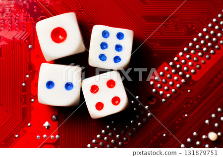 A close-up of the devil's dice lying on an electronic circuit board. The devil's dice are on a microchip. 131879751