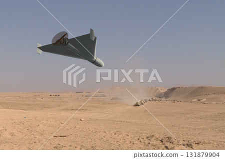 A military kamikaze drone attacks a column of military armoured vehicles in the desert 131879904