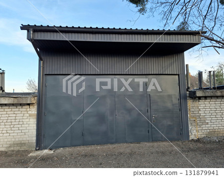 Premises for a car service station. The service station has large metal doors Premises for a car service station. The service station has large metal doors 131879941