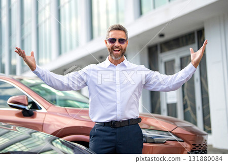 Luxury business success. Rich man near expensive car. Luxury business travel. Successful rich businessman in classic suit. Mature businessman. Rich business man expressing success Luxury business success. Rich man near expensive car. Luxury business travel. Successful rich businessman in classic suit. Mature businessman. Rich business man expressing success 131880084