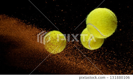 Freeze Motion Shot of Flying Tennis Balls with Clay , Isolated on Black Background 131880106