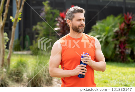 Thirsty man drink water. Sport runner man has thirst. Healthy lifestyle. Water balance in body. Sport man feel thirst drinking water. Hydration vitality. Thirsty runner after workout. Copy space 131880147