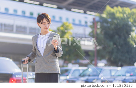 Business woman with a smartphone Business woman with a smartphone 131880153