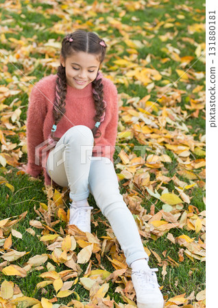 Autumn leaves and nature. Happy childhood. School time. Happy little girl in autumn forest. Perfect place to stay. Small child with autumn leaves. Feeling dry and protected. Ready for new adventures Autumn leaves and nature. Happy childhood. School time. Happy little girl in autumn forest. Perfect place to stay. Small child with autumn leaves. Feeling dry and protected. Ready for new adventures 131880181