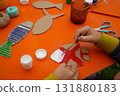 Build a fish sculpture from cardboard materials, thread, and paint, with step-by-step guidance, on an orange background. 131880183