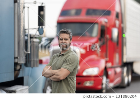 Handsome man driver in front of truck. Trucking owner. Truck driver. Man trucker driver near lorry truck. Transportation vehicles. Semi trucks vehicle. Hispanic man trucker. Logistics service 131880204