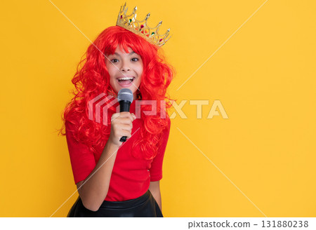 positive kid in crown with microphone on yellow background positive kid in crown with microphone on yellow background 131880238