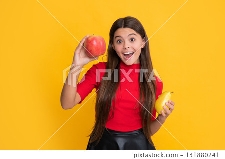 smiling amazed child hold apple and pear on yellow background smiling amazed child hold apple and pear on yellow background 131880241