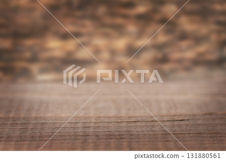 Rustic wooden table on warm brown surface with blurred background for home and cafe scenes Rustic wooden table on warm brown surface with blurred background for home and cafe scenes 131880561
