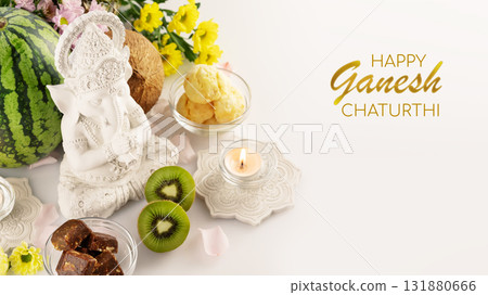 Holiday of Ganesh Chaturthi. Greeting card with sculpture of Ganesha with offerings, fruits, sweets, flowers and candles on white background with congratulation text. Lord Ganesha, Ganesh festival Holiday of Ganesh Chaturthi. Greeting card with sculpture of Ganesha with offerings, fruits, sweets, flowers and candles on white background with congratulation text. Lord Ganesha, Ganesh festival 131880666
