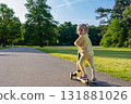 Scooter and kid. Toddler outdoor riding. Fun yellow play childhood freedom. 131881026